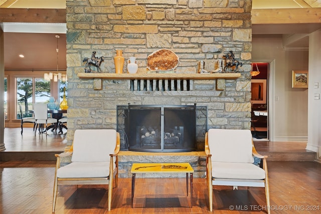 living room featuring hardwood / wood-style flooring, a fireplace, and beam ceiling