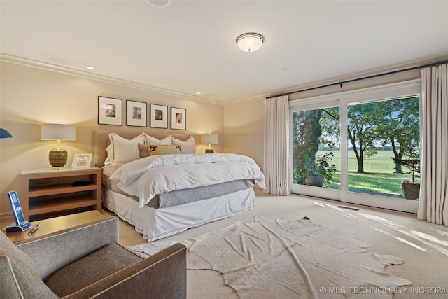 carpeted bedroom with ornamental molding and access to outside