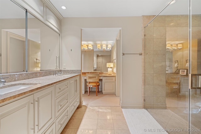 bathroom featuring tile patterned floors, tiled shower, and vanity