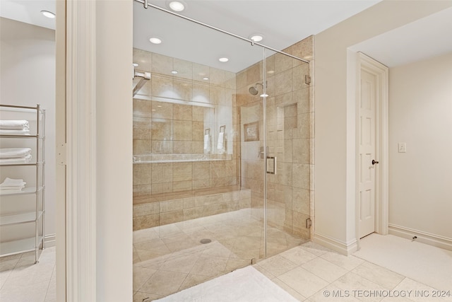 bathroom with walk in shower and tile patterned flooring