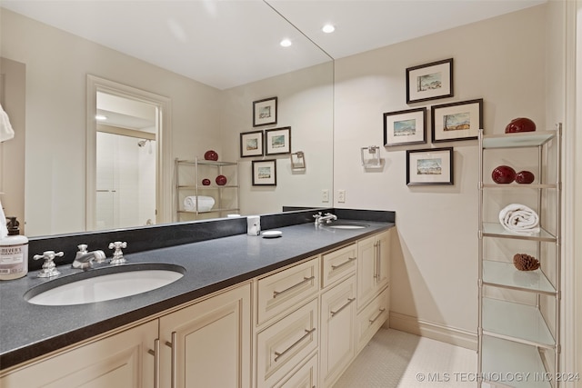 bathroom with vanity, a shower, and tile patterned floors