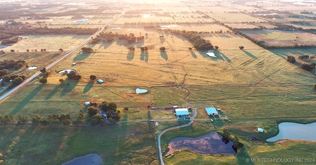 aerial view with a water view and a rural view