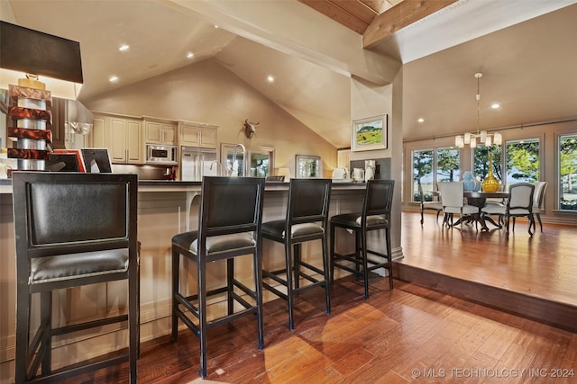 bar with high vaulted ceiling, built in appliances, cream cabinets, beam ceiling, and light hardwood / wood-style floors