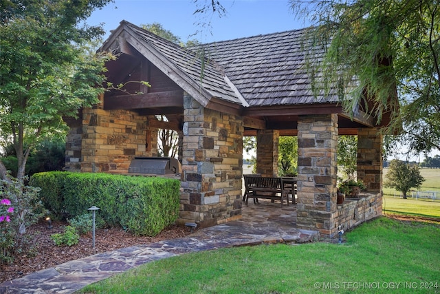 exterior space with area for grilling, a patio, and a front yard