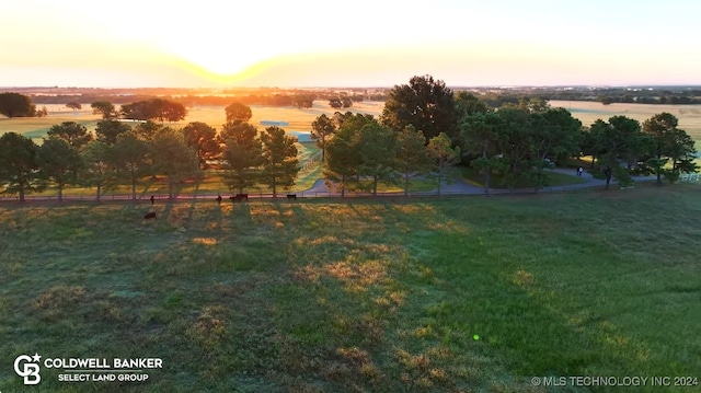 yard at dusk with a water view and a rural view