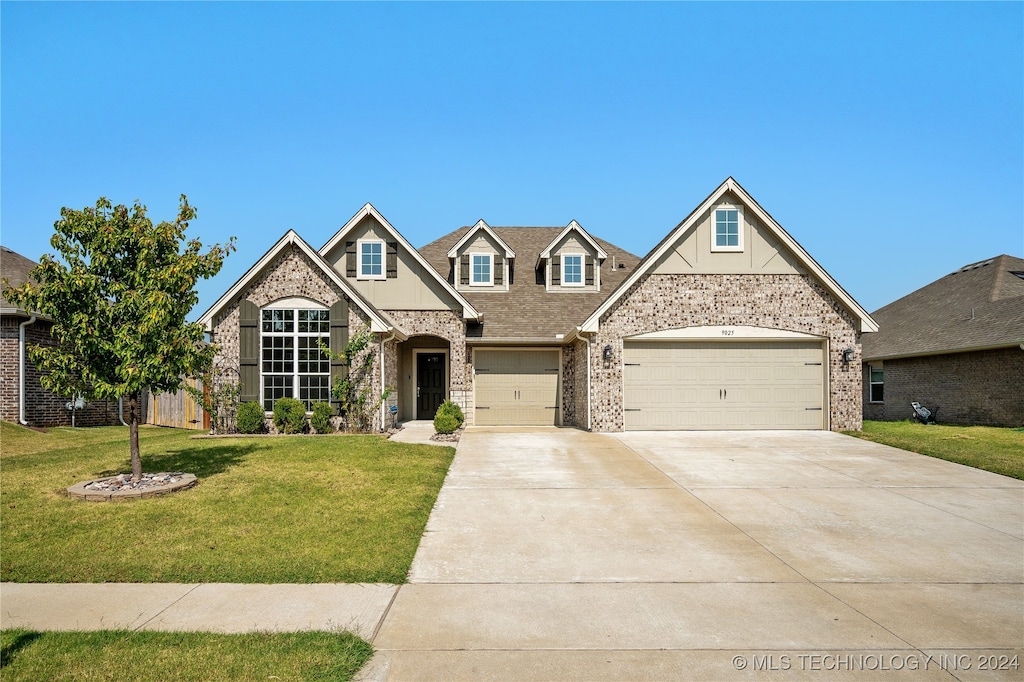 view of front of house with a garage and a front yard