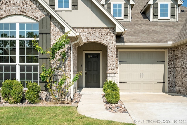 view of exterior entry with a garage