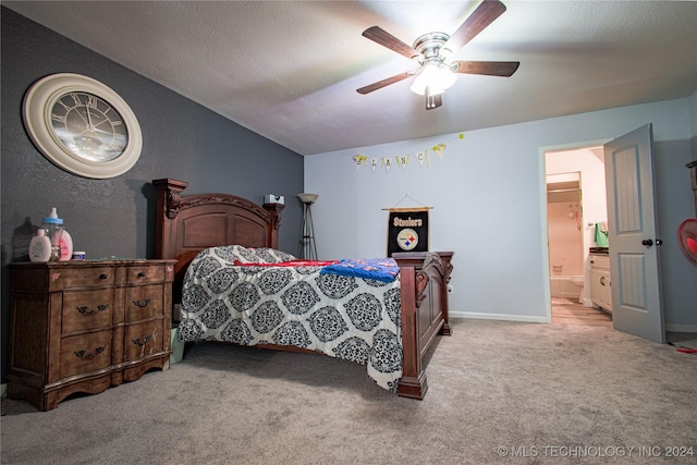 carpeted bedroom featuring a textured ceiling, ceiling fan, vaulted ceiling, and ensuite bath