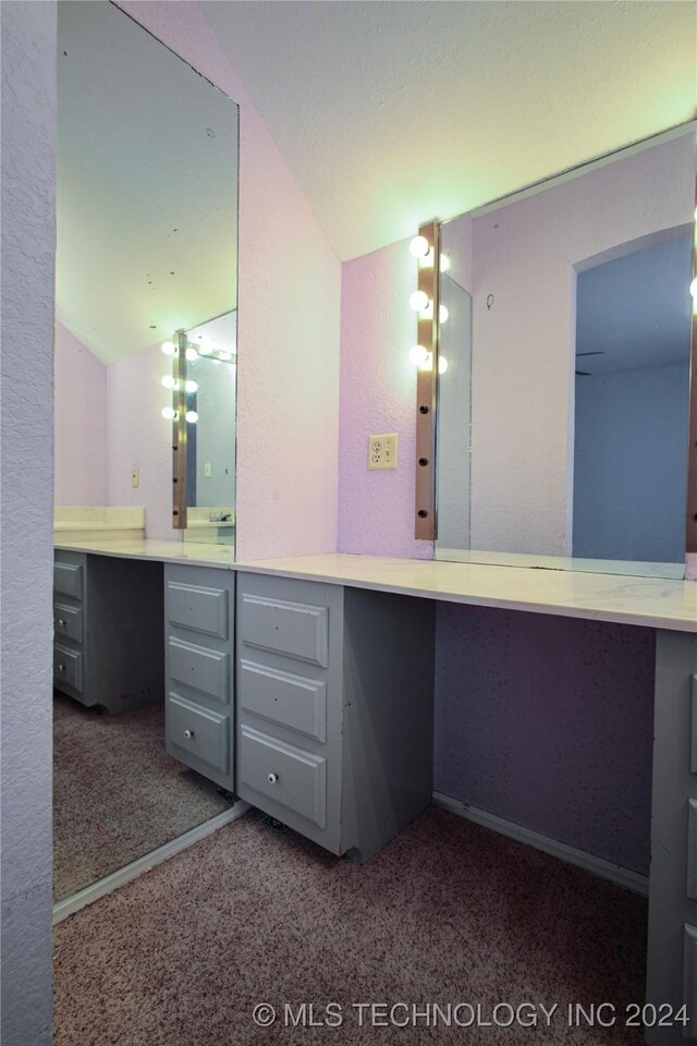 bathroom featuring vanity and vaulted ceiling