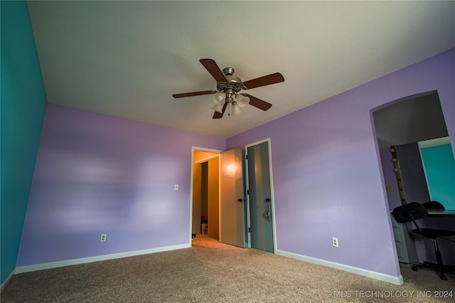 unfurnished bedroom featuring ceiling fan and carpet floors