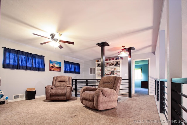 carpeted living area with visible vents, baseboards, and a ceiling fan