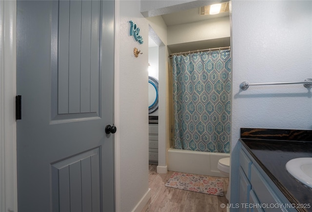 full bathroom featuring wood-type flooring, toilet, vanity, and shower / bath combo