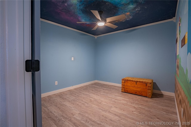 empty room with ceiling fan, ornamental molding, and light wood-type flooring