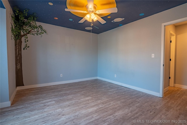 empty room with ceiling fan and wood-type flooring