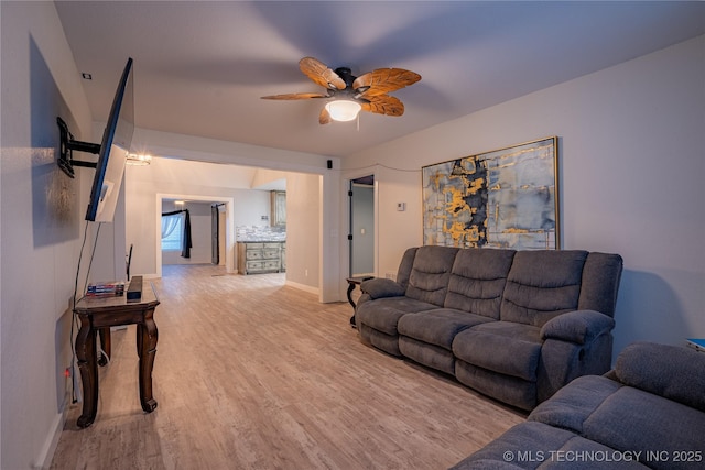 living room with ceiling fan and light wood-type flooring