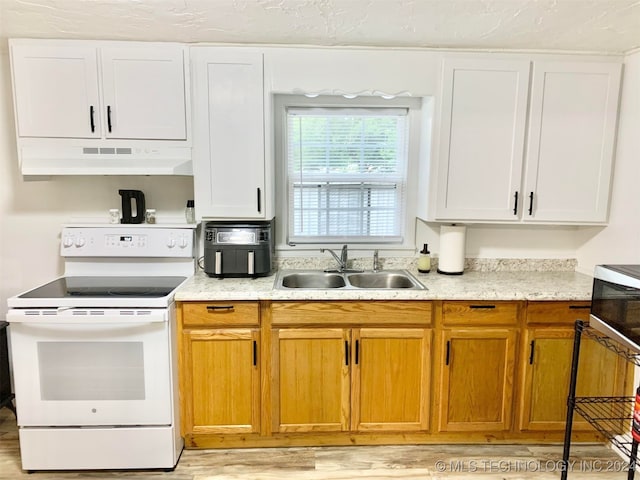 kitchen featuring white range with electric stovetop, sink, white cabinetry, and light hardwood / wood-style floors