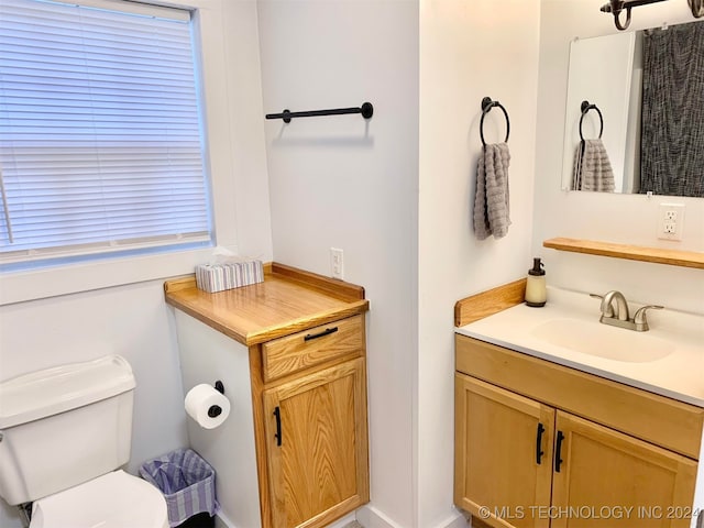 bathroom featuring vanity and toilet