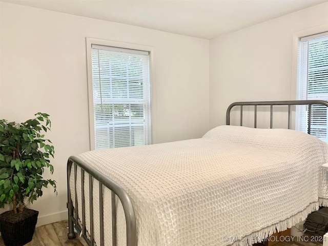 bedroom with hardwood / wood-style flooring