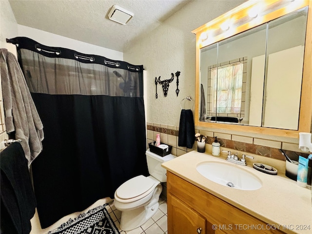 bathroom featuring tasteful backsplash, tile patterned floors, vanity, a textured ceiling, and toilet