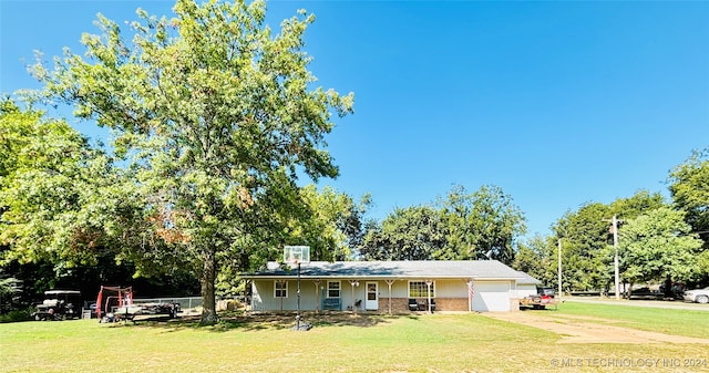 ranch-style house with a front yard and a garage