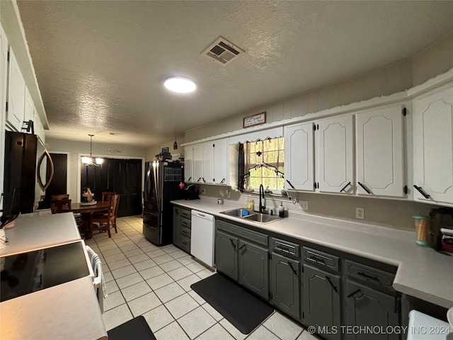 kitchen featuring dishwasher, stove, sink, decorative light fixtures, and white cabinetry