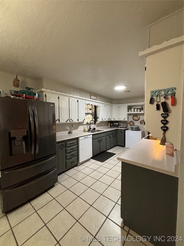 kitchen with dishwasher, white cabinets, sink, light tile patterned floors, and black fridge with ice dispenser