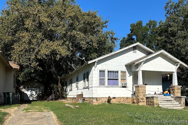 view of front of property with a garage and a front lawn