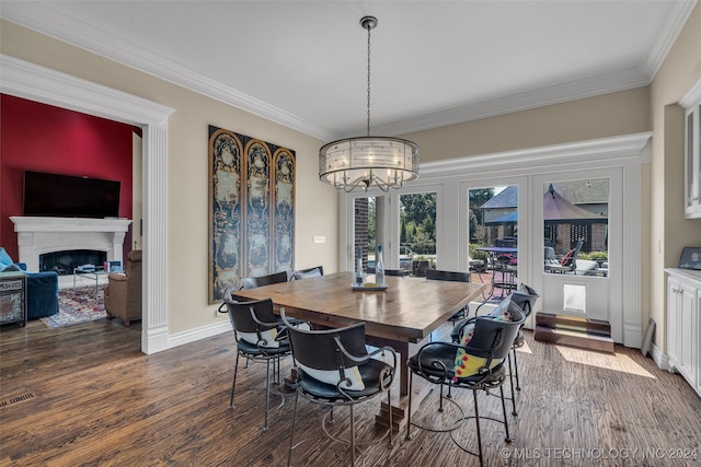 dining room featuring french doors, an inviting chandelier, crown molding, and dark hardwood / wood-style flooring