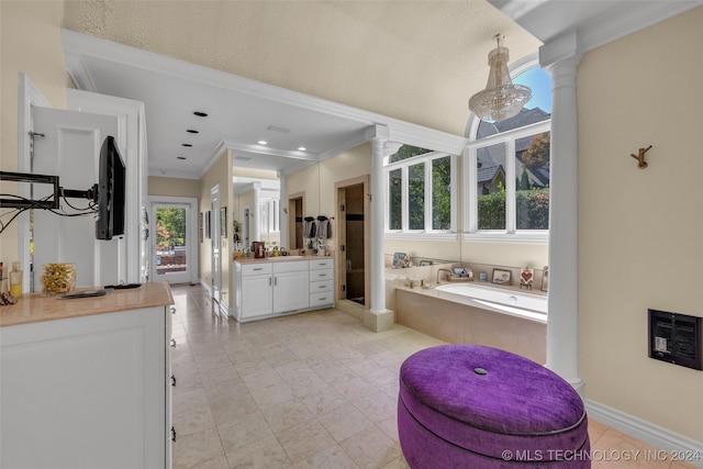 bathroom with heating unit, a bathing tub, crown molding, vanity, and ornate columns