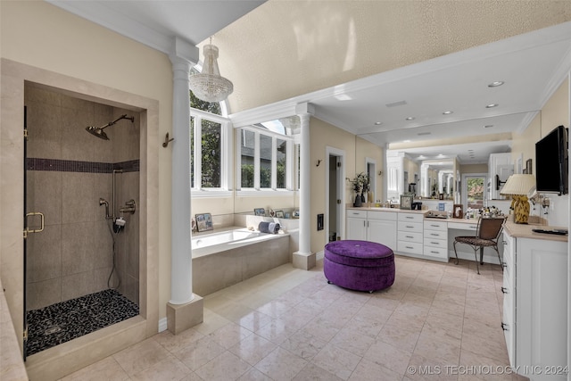 bathroom featuring ornamental molding, decorative columns, independent shower and bath, and vanity