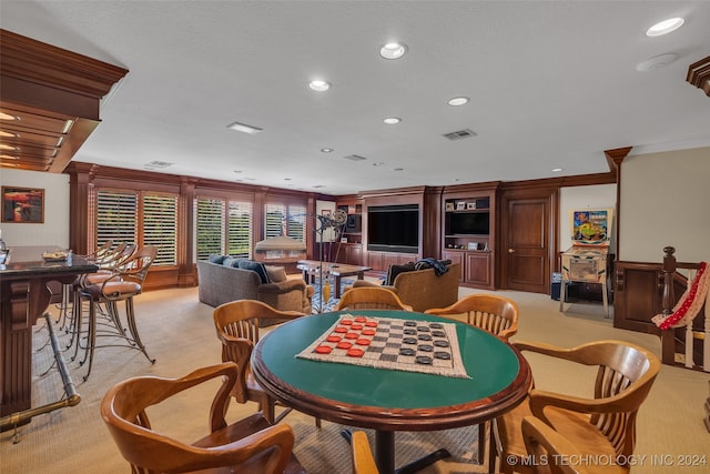 carpeted dining area featuring crown molding