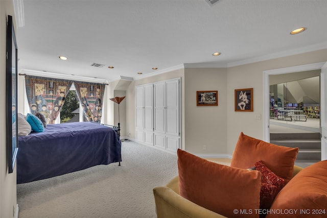 bedroom with ornamental molding and carpet