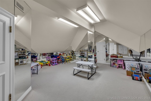 recreation room with carpet floors and lofted ceiling