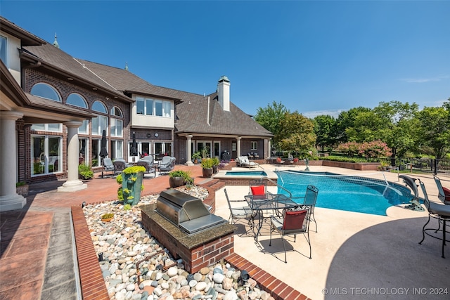 view of swimming pool with a patio area and pool water feature