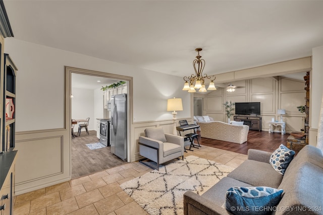 living room with light hardwood / wood-style flooring and an inviting chandelier