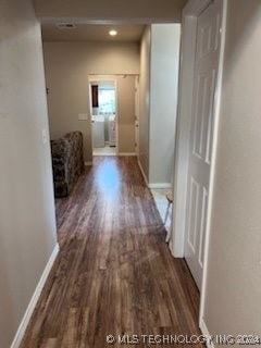 hallway featuring dark hardwood / wood-style flooring