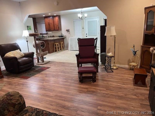 living room featuring an inviting chandelier and hardwood / wood-style flooring