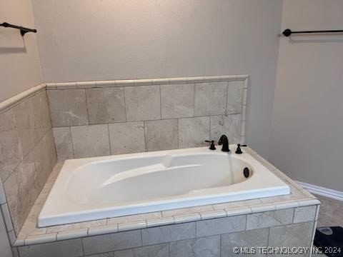 bathroom featuring tiled bath