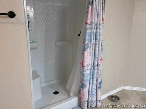 bathroom with tile patterned flooring and curtained shower