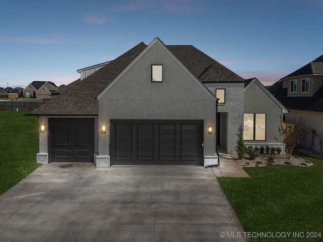 view of front facade with a lawn and a garage