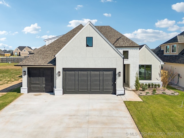 modern inspired farmhouse with a garage and a front yard