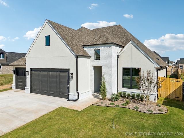 view of front of house featuring a garage and a front lawn