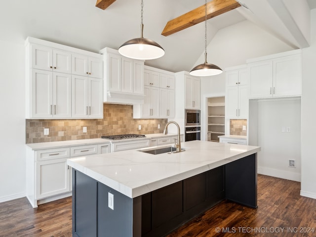 kitchen featuring sink, hanging light fixtures, vaulted ceiling with beams, appliances with stainless steel finishes, and white cabinetry