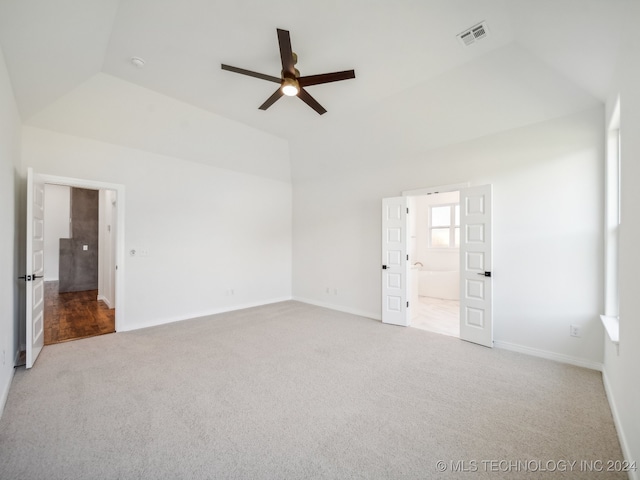 carpeted spare room featuring ceiling fan and lofted ceiling