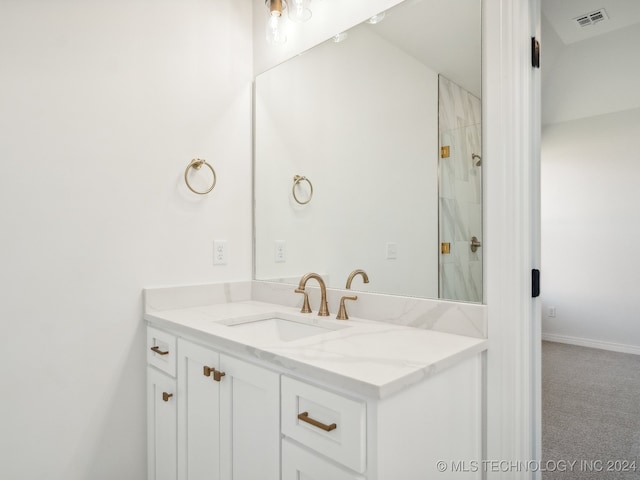 bathroom featuring vanity and a tile shower