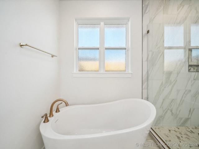 bathroom with plus walk in shower and a wealth of natural light