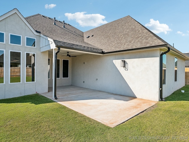 back of house featuring a patio area, ceiling fan, and a yard