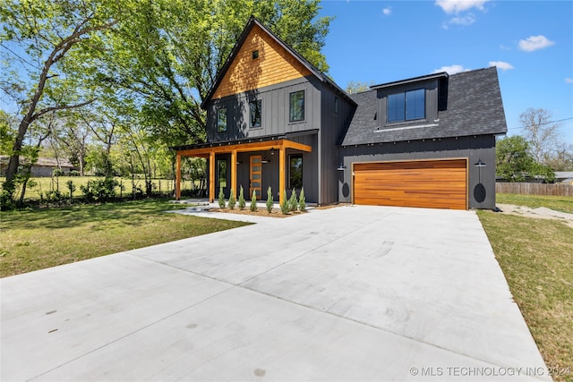 view of front of house with a garage and a front lawn