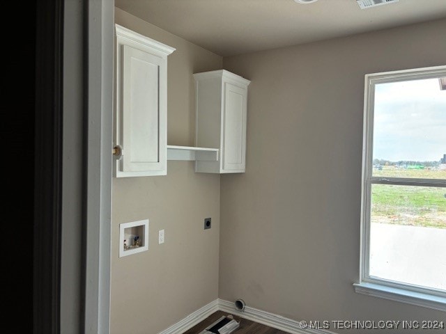 clothes washing area with hookup for a washing machine, cabinets, plenty of natural light, and electric dryer hookup