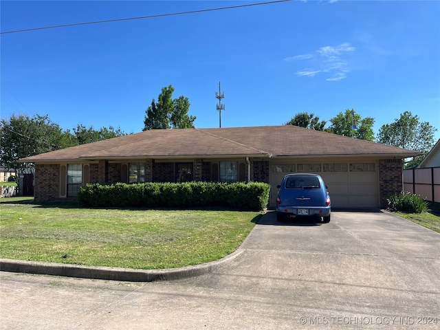 single story home with a garage, driveway, a front lawn, and brick siding